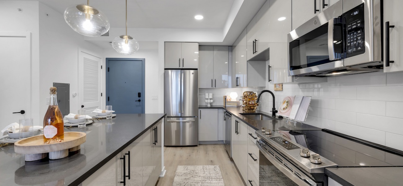 Spacious well lit kitchen with wood floors and large windows  Spacious well lit kitchen with wood floors and large windows