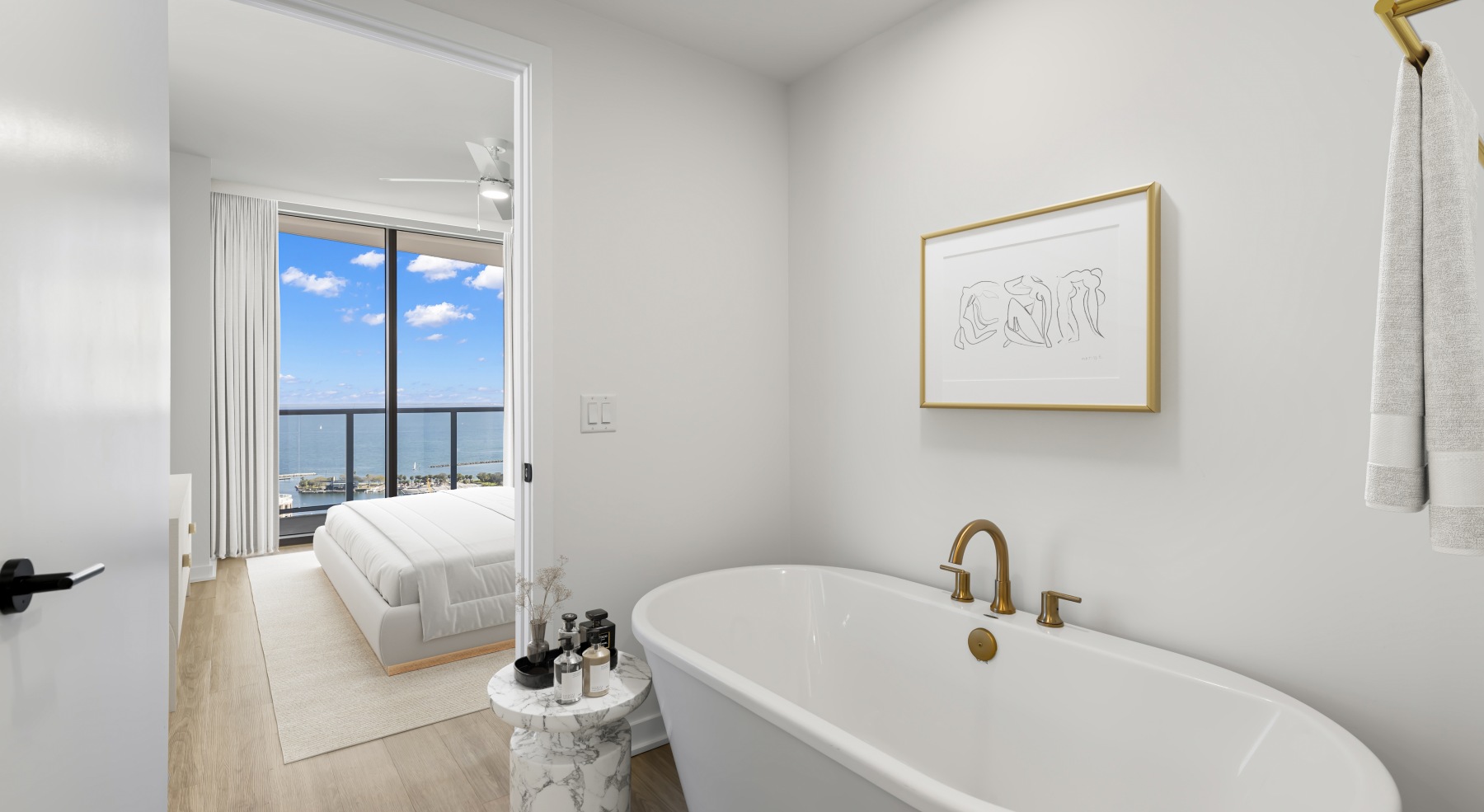 ascent st pete bathroom vanity halo lit mirror oval soaking tub toilet wood floors bedroom view bed blue sky balcony ascent st pete bathroom vanity halo lit mirror oval soaking tub toilet wood floors bedroom view bed blue sky balcony