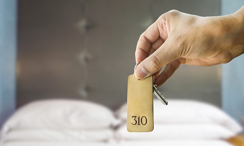 Self-Guided Tours Prospective resident holding keys to model apartment for self-guided tour